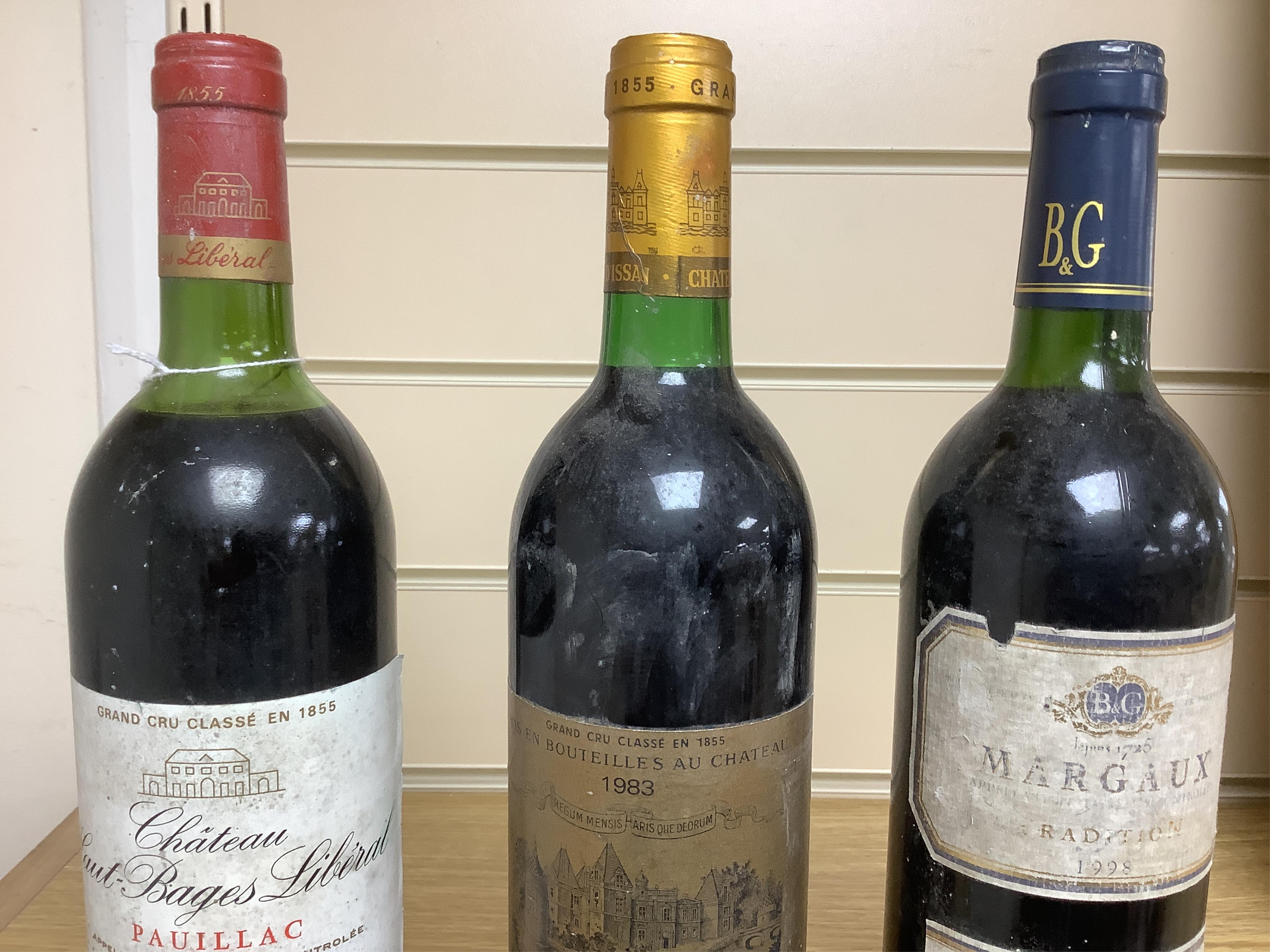 Three bottles of red wine: Chateau D’Issan Margaux 1983, Chateau Haut-Bages Liberal 1983 and Margaux 1998. Condition - good